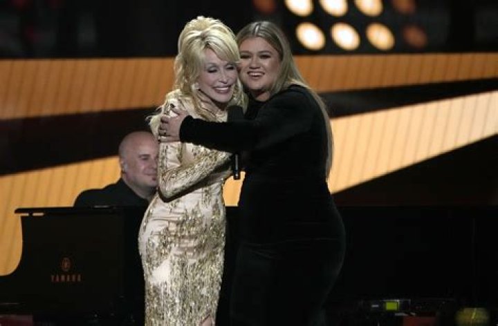 Dolly Parton, left, and Kelly Clarkson embrace onstage at the 57th Academy of Country Music Awards, at Allegiant Stadium in Las Vegas 57th ACM Awards - Show, Las Vegas, United States - 07 Mar 2022